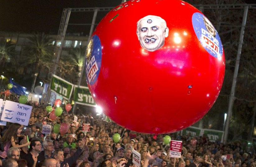 Protesters rally in Tel Aviv, March 7, for a change of government ahead of general elections