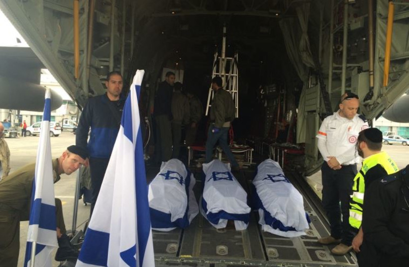 The coffins of three Israelis killed in the Istanbul suicide bombing are loaded onto an IAF transport plane