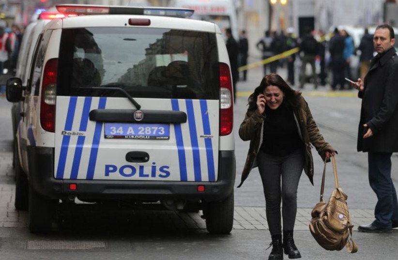 A woman reacts following a suicide bombing in a major shopping and tourist district in central Istanbul