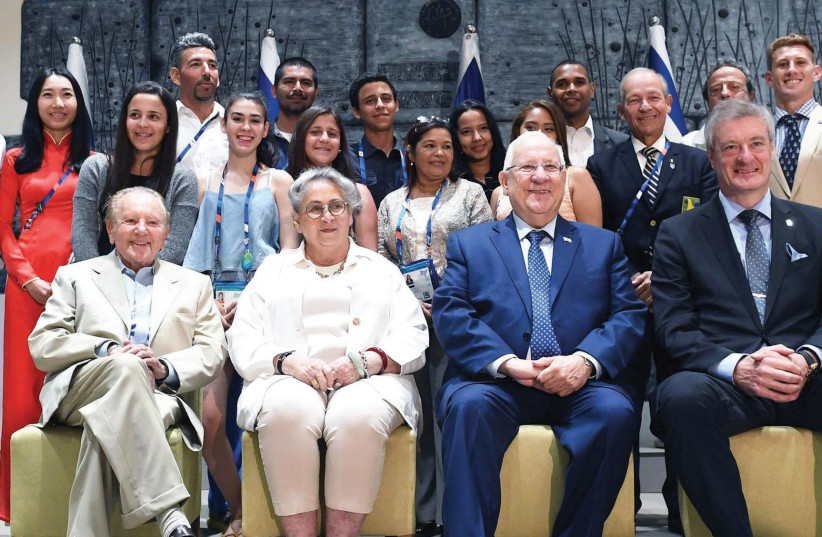 President Reuven Rivlin (first row, third from left) and his wife Nechama (first row, second from left) welcomed Maccabi World Union chiefs, heads of delegations and Maccabiah athletes yesterday to their official residence in Jerusalem (photo credit: MARK NEYMAN / GPO)
