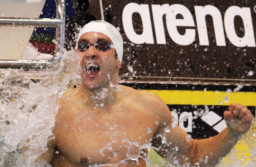 Jonatan Kopelev of Israel celebrates victory in the men's 50m backstroke final at the 2012 European Swimming Championship in Debrecen (photo credit: REUTERS/LASZLO BALOGH)