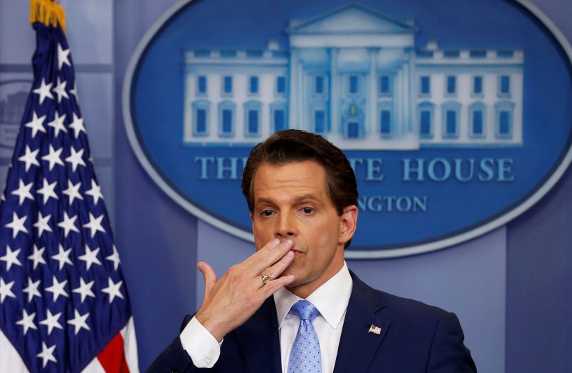 White house Communications Director Anthony Scaramucci (R)), flanked by White House Press Secretary Sarah Sanders, blows a kiss to reporters after addressing the daily briefing at the White House in Washington, July 21, 2017.  (photo credit: REUTERS)