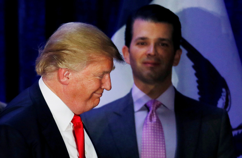 Donald Trump Jr. (R) watches his father Republican US presidential candidate Donald Trump leave the stage on the night of the Iowa Caucus (photo credit: JIM BOURG / REUTERS)