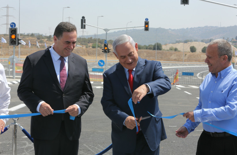 Israel's Transportation Minister and Prime Minister Netanyahu cut the ribbon on new road.  (photo credit: SASSON TIRAM)