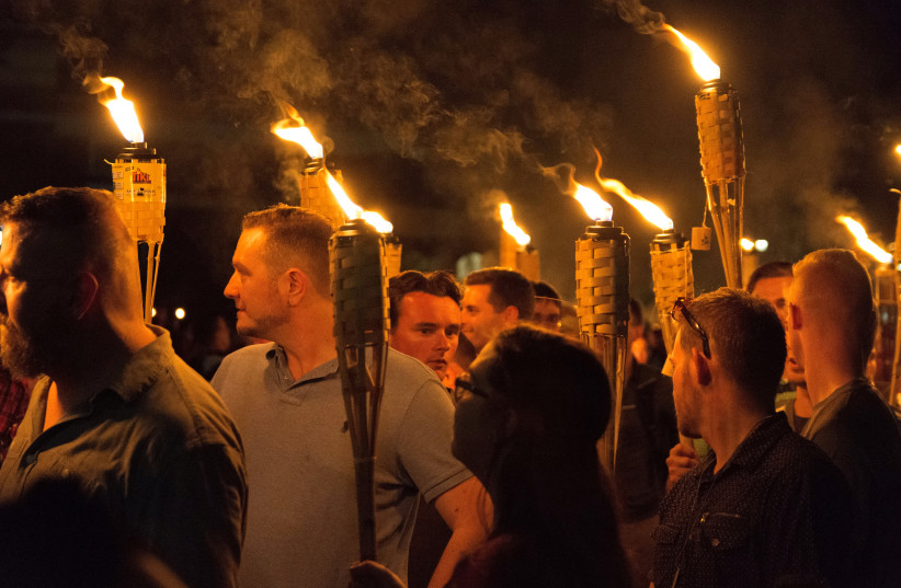 White nationalists carry torches on the grounds of the University of Virginia (photo credit: ALEJANDRO ALVAREZ/NEWS2SHARE VIA REUTERS)