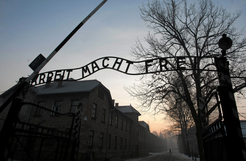 The Nazi slogan "Arbeit macht frei" (Work sets you free) is pictured at the gates of the former Nazi German concentration and extermination camp Auschwitz-Birkenau in Oswiecim, Poland January 27, 2017. (photo credit: AGENCY GAZETA/KUBA OCIEPA/VIA REUTERS)