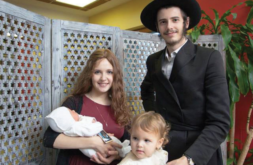 Rachel and David Shapiro with their daughter, Chaya Mushka, and newborn son Menachem Mendel in Moscow, in June (photo credit: THE ROGATCHI FOUNDATION)