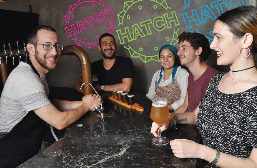 Ephraim Greenblatt (left) serves ‘real food’ and ‘real beer’ at Hatch. (photo credit: MIKE HORTON)
