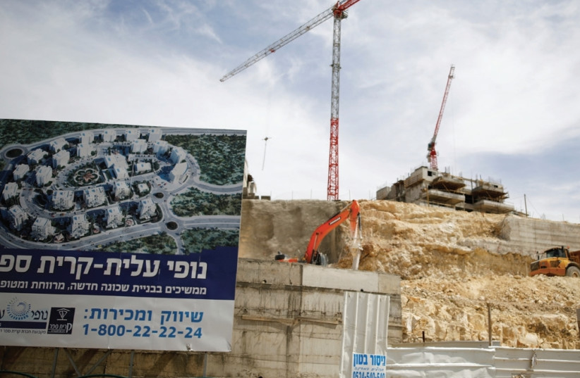 BUILDINGS UNDER CONSTRUCTION as seen in Modi’in Illit, northwest of Jerusalem, in March (photo credit: REUTERS)
