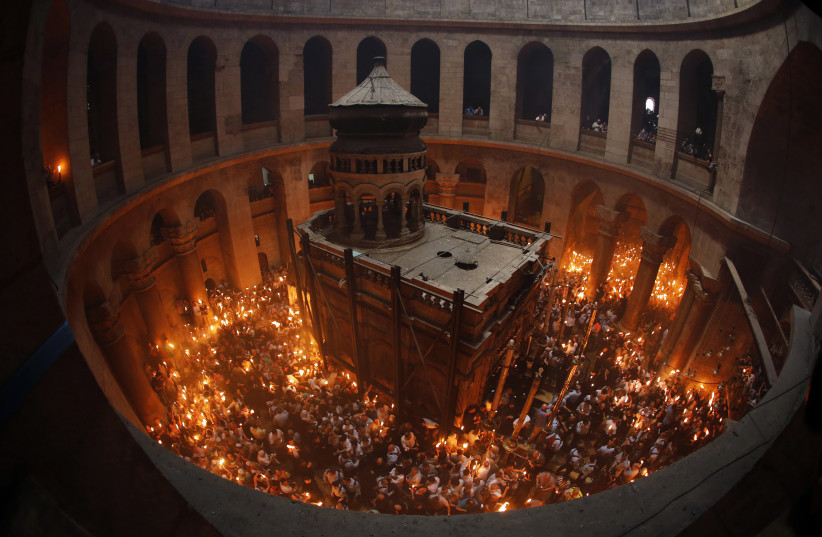 Worshippers hold candles as they take part in the Christian Orthodox Holy Fire ceremony at the Church of the Holy Sepulchre in Jerusalem's Old city May 4, 2013.  (photo credit: REUTERS/AMMAR AWAD)
