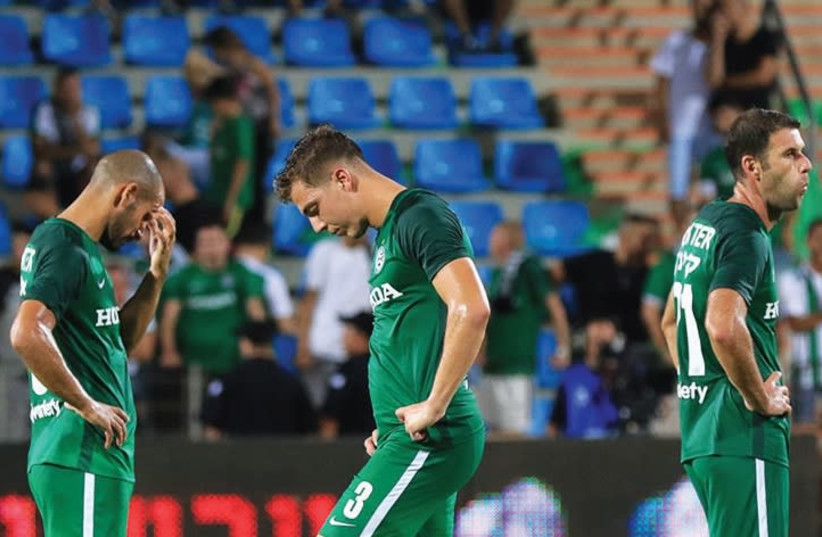 Maccabi Haifa players (from left) Gal Alberman, Shay Ben-David and Dekel Keinan had a difficult time accepting last night’s dejecting 2-0 defeat at Hapoel Acre. (photo credit: ERAN LUF)