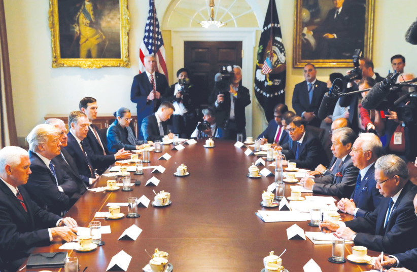 US President Donald Trump hosts a recent meeting at the White House. His administration, the author writes, has enabled intolerance and fake-news era extremists. (photo credit: REUTERS)