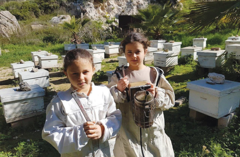 wo of Yael Farbstein’s daughters in protective gear at Kedumim Honey.  (photo credit: KEDUMIM HONEY)