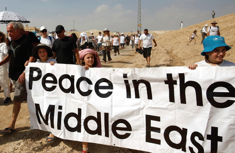 DEMONSTRATORS, INCLUDING Israeli and Palestinian activists, take part in a demonstration in support of peace last year (photo credit: REUTERS)