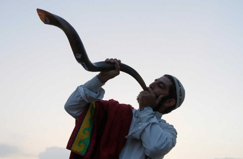 An ultra-Orthodox Jewish pilgrim blows a shofar, near the tomb of Rabbi Nachman of Breslov during the celebration of Rosh Hashanah holiday, the Jewish New Year, in Uman, Ukraine, September 21, 2017. (photo credit: REUTERS)