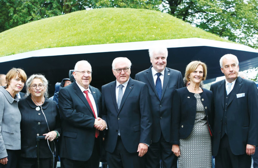 Germany's President Frank-Walter Steinmeier and Israel's President Reuven Rivlin(C) stand with dignitaries at the Munich Memorials.  (photo credit: REUTERS)