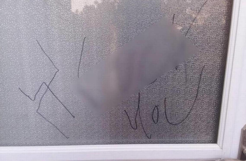 A couple in southwest Charlotte, North Carolina, returned home after a Rosh Hashanah event to find a swastika and profanity written on their door. The profanity was blurred out by The Charlotte Observer. (photo credit: RONALD GALE/THE CHARLOTTE OBSERVER/TRIBUNE NEWS SERVICE)