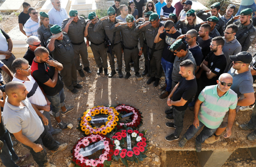 Israeli security officers, friends and relatives attend the funeral of Youssef Ottman, killed in a Palestinian shooting attack in Har Adar, September 26, 2017. (photo credit: RONEN ZVULUN/REUTERS)