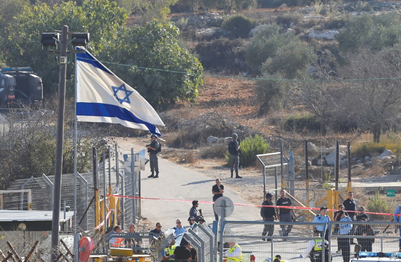 A general view shows where a Palestinian terrorist killed three Israeli guards and wounded a fourth before being killed himself in Har Adar yesterday. (photo credit: AMMAR AWAD / REUTERS)