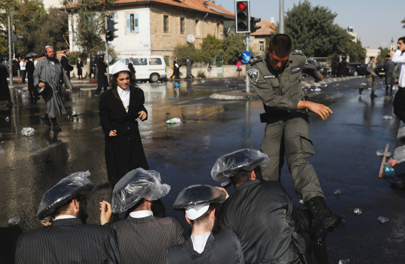 ULTRA-ORTHODOX MEN and police clash during a protest against serving in the Israeli army. (photo credit: REUTERS)
