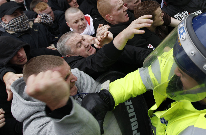 Far-right demonstrators clash with police officers during a march in Leicester, central England, October 9, 2010. (photo credit: REUTERS)