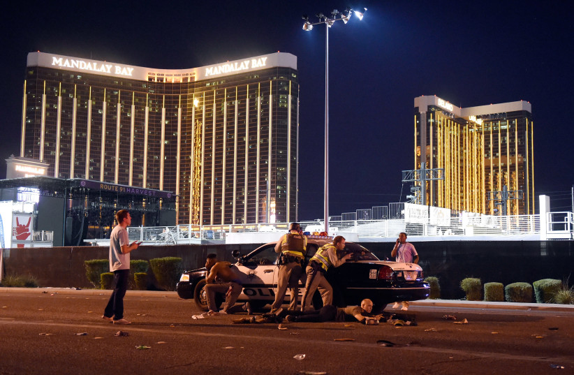 Las Vegas police stand guard along the streets outside the the Route 91 Harvest country music festival grounds after a shooting (photo credit: DAVID BECKER/GETTY IMAGES/AFP)