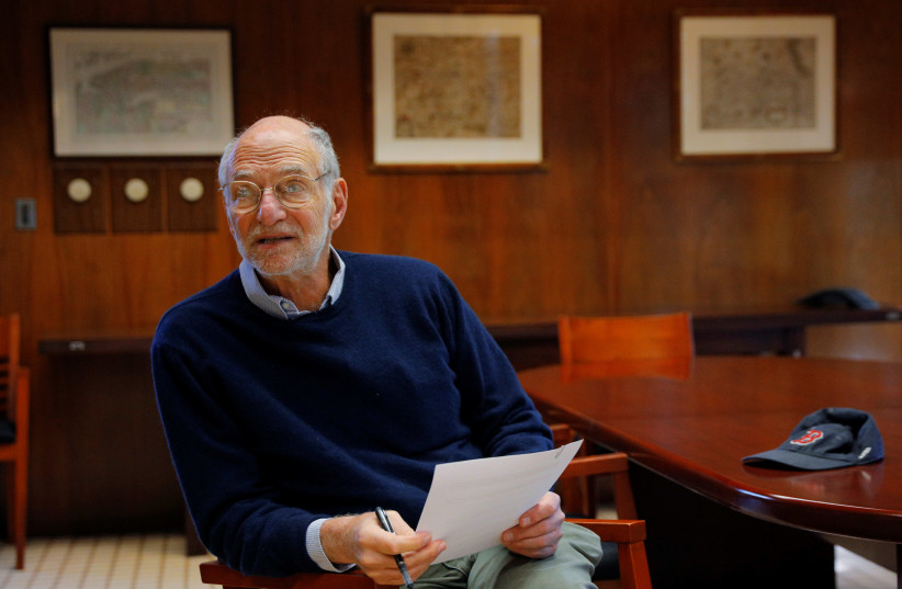Michael Rosbash, a Brandeis University professor, proof-reads a press release after being named as a co-winner of the 2017 Nobel Prize in Physiology or Medicine. (photo credit: REUTERS/BRIAN SNYDER)