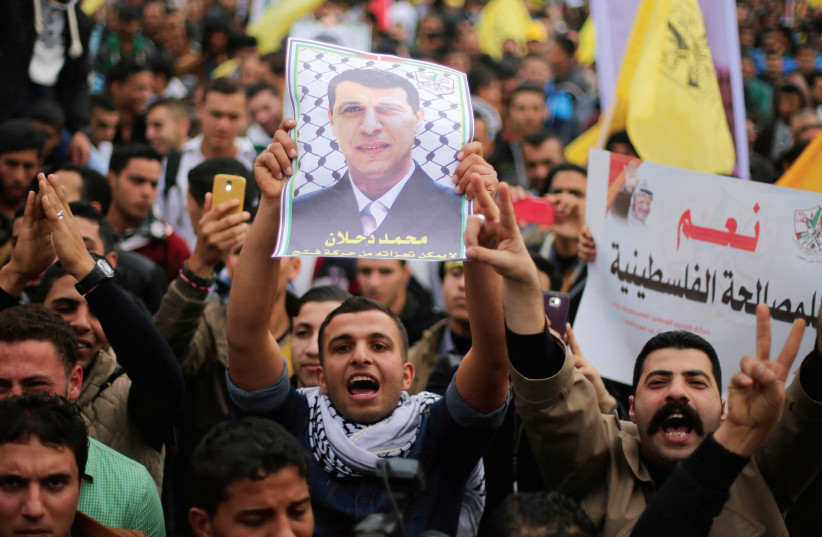 PALESTINIANS HOLD a poster of Mohammed Dahlan at a rally in Gaza city in 2014. (photo credit: REUTERS)