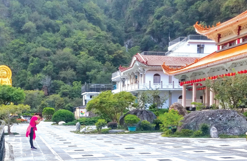 A WOMAN prays outside a Buddhist Temple in Taroko Gorge. (photo credit: SUSAN LERNER)