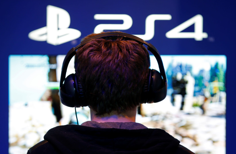A visitor plays games on PlayStation 4 (PS4). (photo credit: REUTERS)
