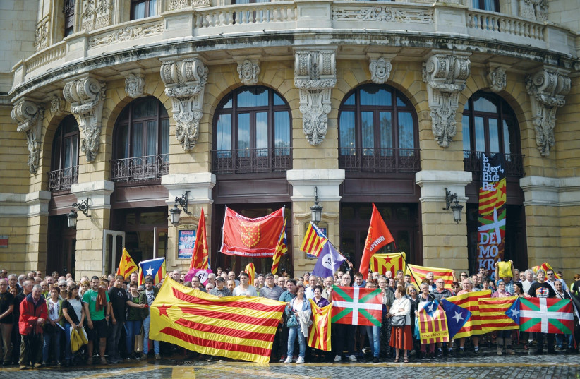 PROTESTERS CARRY Esteladas, Catalan separatist flags and Basque flags (photo credit: REUTERS)