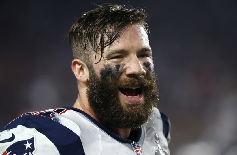 New England Patriots wide receiver Julian Edelman smiles on the sidelines during the NFL Super Bowl XLIX football game against the Seattle Seahawks in Glendale, Arizona, February 1, 2015.  (photo credit: LUCY NICHOLSON / REUTERS)
