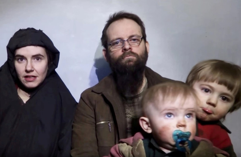 A still image from a video posted by the Taliban on social media on December 19, 2016 shows American Caitlan Coleman (L) speaking next to her Canadian husband Joshua Boyle and their two sons. (photo credit: REUTERS)