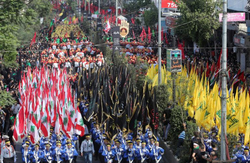 Supporters of Lebanon's Hezbollah party parade to mark the last day of Ashura ceremony in Beirut, Lebanon October 1, 2017. (photo credit: AZIZ TAHER/REUTERS)