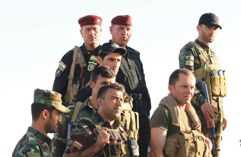 Kurdish Peshmerga fighters are seen yesterday in the Karez area west of Mosul, Iraq. (photo credit: ARI JALAL / REUTERS)