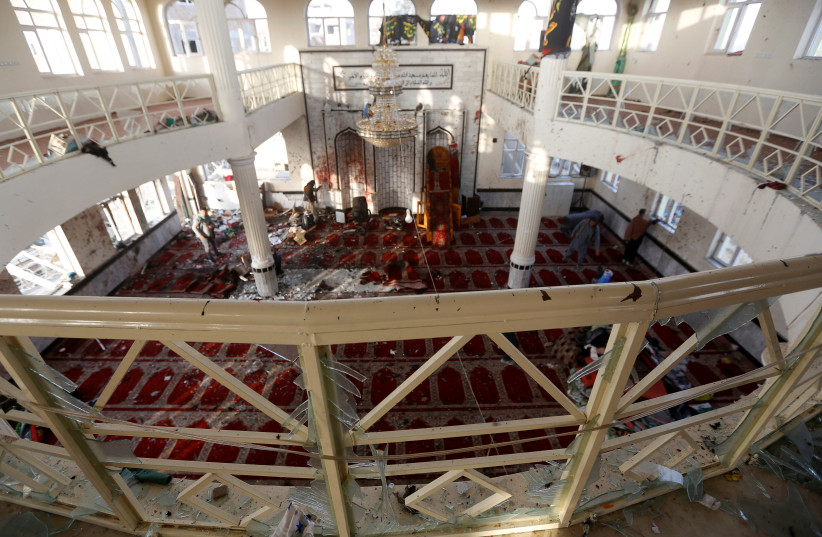Afghan men inspect inside a Shi'ite Muslim mosque after an attack in Kabul, Afghanistan. (photo credit: REUTERS)