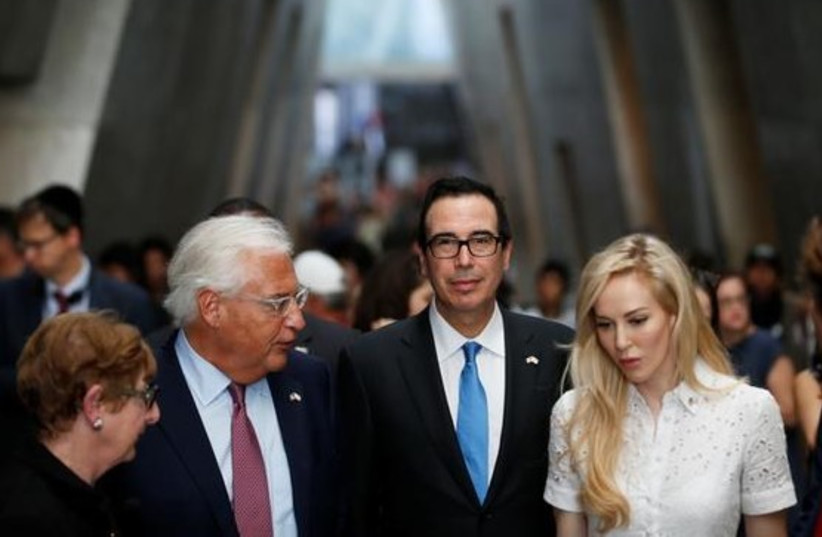 US Treasury Secretary Steven Mnuchin and his wife Louise Linton are accompanied by US Ambassador to Israel David Friedman during their visit to Yad Vashem's Holocaust History Museum in Jerusalem October 26, 2017. (photo credit: REUTERS/Ronen Zvulun)