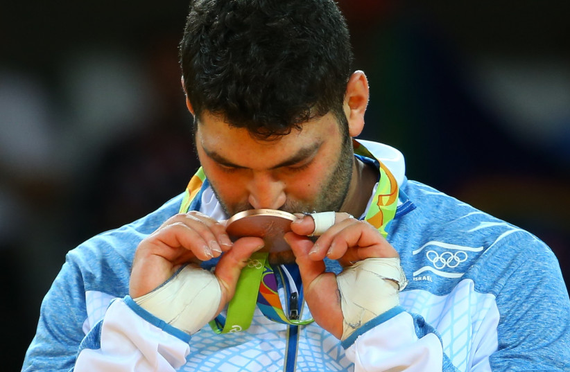 Or Sasson of Israel kisses his medal at the 2016 Rio Olympics (photo credit: REUTERS)