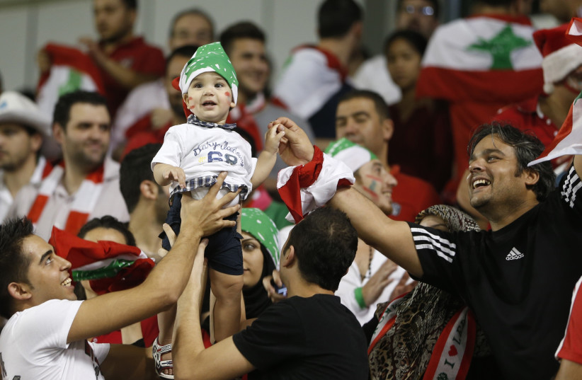 Fans of Lebanon cheer for their team during their 2014 World Cup qualifying soccer match against Qatar in Doha, November 14, 2012. (photo credit: REUTERS)