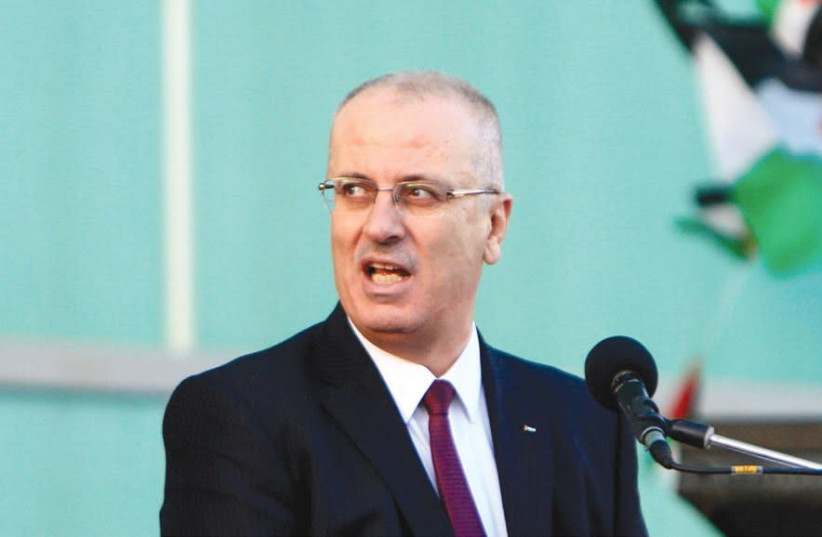 PALESTINIAN AUTHORITY Prime Minister Rami Hamdallah speaks during a mass wedding ceremony for 27 couples in Jenin last year. (photo credit: ABED OMAR QUSINI/REUTERS)