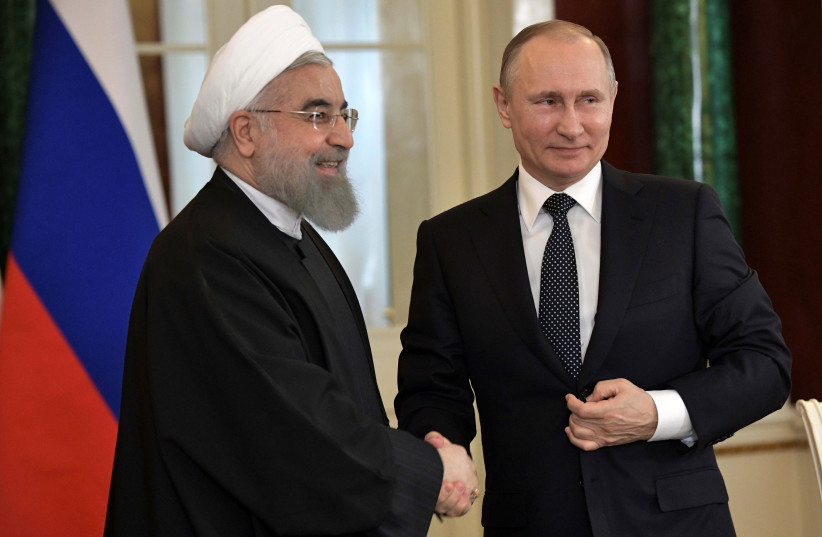 Russian President Vladimir Putin shakes hands with Iranian President Hassan Rouhani following their meeting at the Kremlin in Moscow, March 28, 2017. (photo credit: REUTERS)