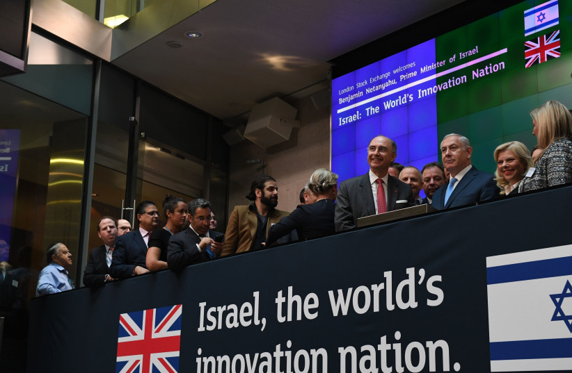 Prime Minister Benjamin Netanyahu and his wife Sara Netanyahu at the opening of the London stock exchange  (photo credit: KOBI GIDEON/GPO)
