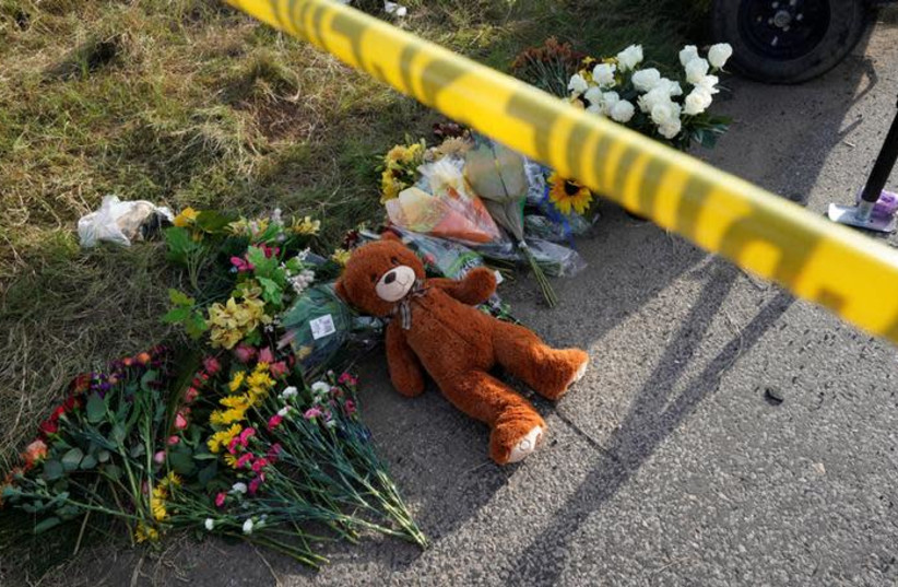 A Teddy bear lies under police tape at a makeshift memorial for those killed in the shooting at the First Baptist Church of Sutherland. (credit: RICK WILKING/REUTERS)