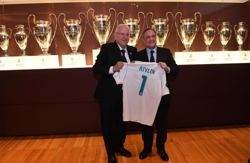 President Reuven Rivlin receives Real Madrid shirt from Florentino Perez, President of Real Madrid. (photo credit: CHAIM TZACH/GPO)
