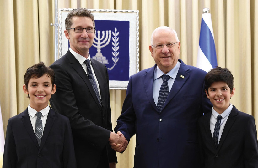PRESIDENT REUVEN RIVLIN poses with Australian Ambassador Chris Cannan and the envoy’s twin sons after accepting his credentials on August 8. (photo credit: MARK NEYMAN / GPO)