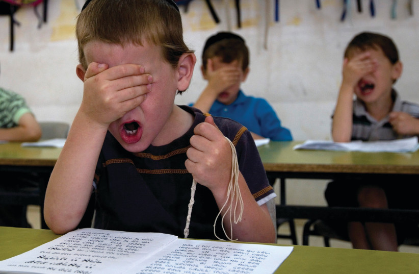 PUPILS PRAY at the Kehilot Ya’acov Torah School for Boys in Jerusalem (photo credit: REUTERS/Ronen Zvulun)