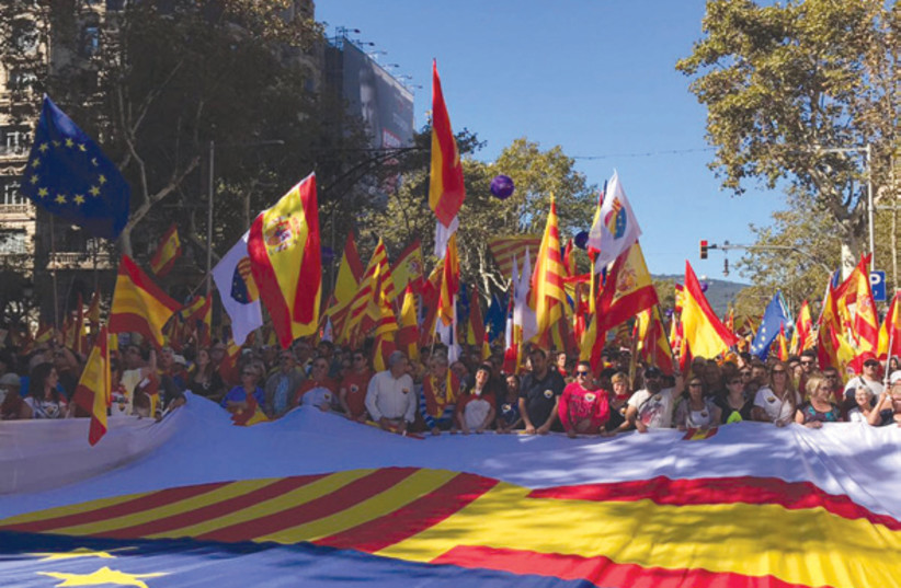 Several Jews were among those attending a unity march in Barcelona on October 29, with a sea of Spanish and Catalan flags in the background (photo credit: STEPHEN BERKOWITZ)