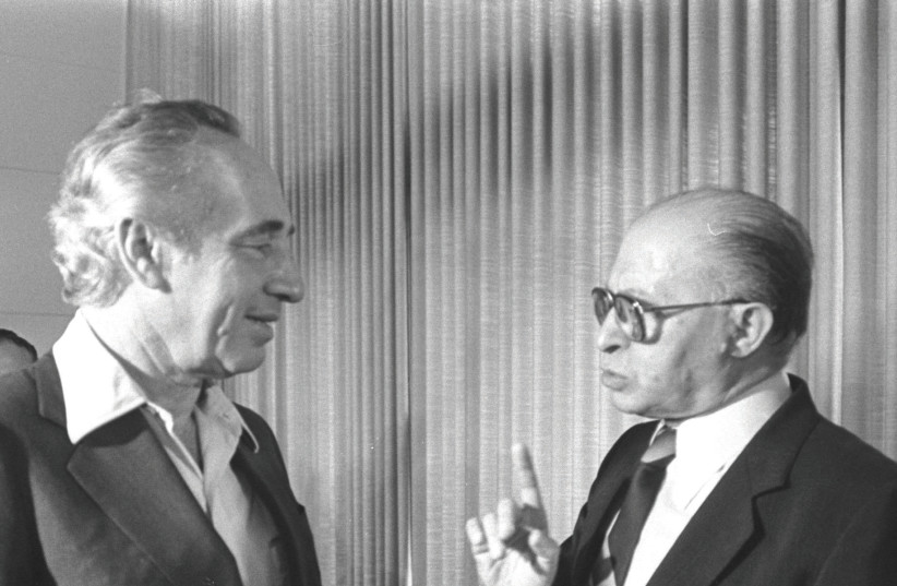 Shimon Peres and Menachem Begin chat at the inaugural session of the 10th Knesset in 1981 (photo credit: GPO)