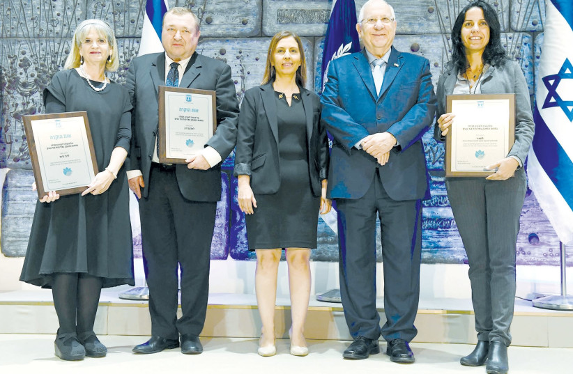 PRESIDENT REUVEN RIVLIN poses yesterday with Social Equality Minister Gila Gamliel (center) and prizewinners (from left to right) Debbie Gross, Alex Levin and Einat Agassi, at the President’s Residence in Jerusalem. (photo credit: MARK NEYMAN / GPO)