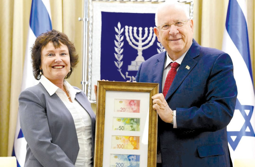 BANK OF ISRAEL Governor Karnit Flug delivers the new banknote series to President Reuven Rivlin at the President’s Residence on Wednesday. (photo credit: MARK NEYMAN/GPO)